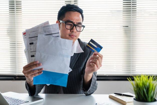 Person stressed about unpaid personal loan bills and overdue payments.