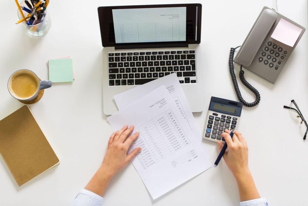 Person reviewing personal loan documents and planning debt settlement strategy.