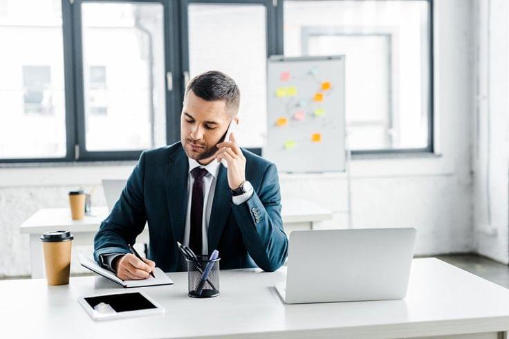 Calm borrower discussing debt settlement terms on a phone call.